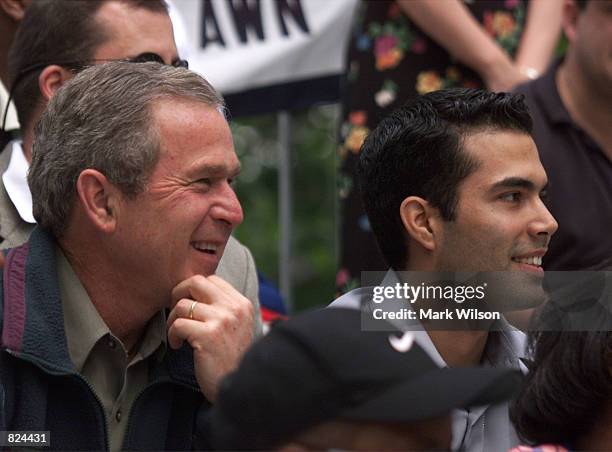 President George W. Bush and his nephew George P. Bush watch a T-ball game on the South Lawn of the White House May 6, 2001 in Washington DC. The...