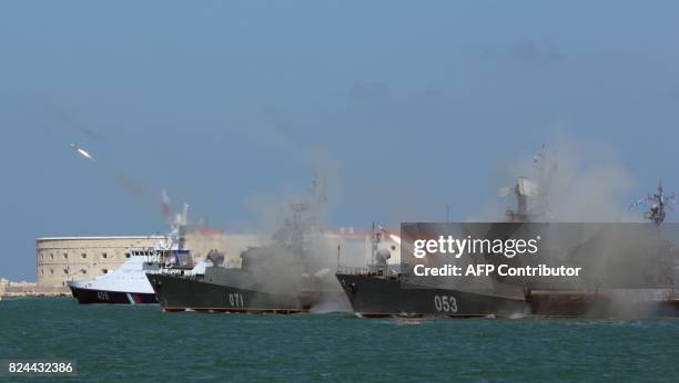 Russian Navy frigates fire missiles during Russia's Navy Day celebration in Sevastopol in Crimea on July 30, 2017. President Vladimir Putin oversaw a...