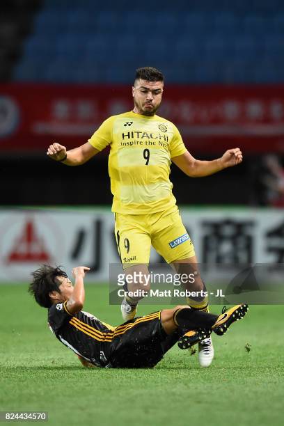 Cristiano of Kashiwa Reysol is tackled by Shingo Tomita of Vegalta Sendai during the J.League J1 match between Vegalta Sendai and Kashiwa Reysol at...