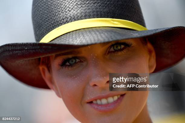 Grid girl smiles at the Hungaroring racing circuit in Budapest on July 30 prior to the Formula One Hungarian Grand Prix. / AFP PHOTO / ANDREJ ISAKOVIC