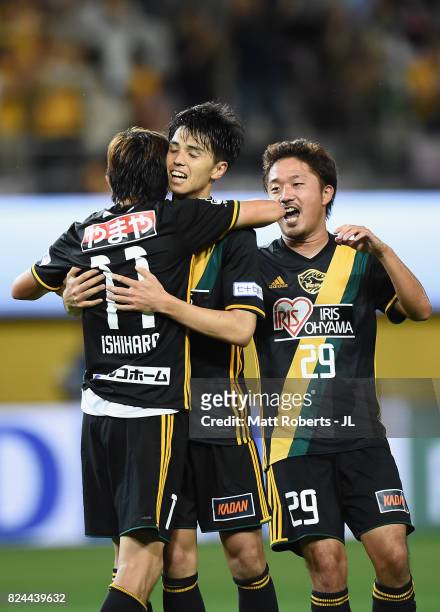 Yoshihiro Nakano of Vegalta Sendai celebrates scoring his side's first goal with his team mates Naoki Ishihara and Shota Kobayashi during the...