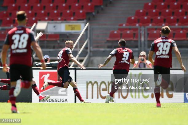 Hanno Behrens of Nuernberg celebrates his team's first goal with team mates during the Second Bundesliga match between 1. FC Nuernberg and 1. FC...