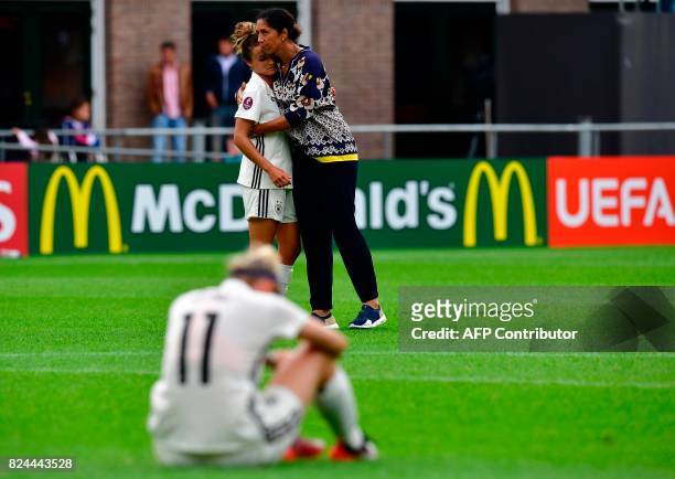 Germany's forward Anja Mittag and head coach head coach Steffi Jones hug as they react after losing the quarter-final UEFA Women's Euro 2017 football...