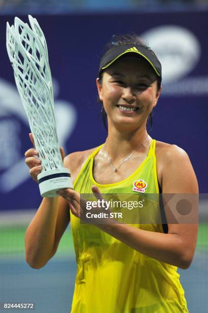 Peng Shuai of China poses with the trophy after defeating Japan's Nao Hibino in the women's singles final at the Jiangxi Open WTA tennis tournament...