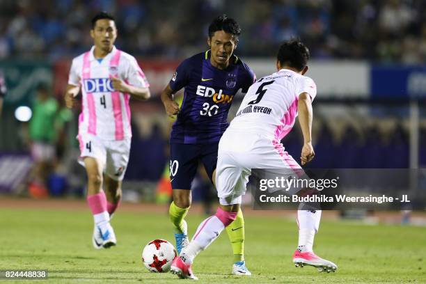 Kosei Shibasaki of Sanfrecce Hiroshima takes on Kim Min Hyeok of Sagan Tosu during the J.League J1 match between Sanfrecce Hiroshima and Sagan Tosu...