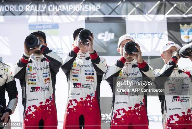 Toyota's Finnish driver Esapekka Lappi and co-pilot Janne Färm celebrate on podium after winning the Neste Rally Finland 2017 in Jyväskylä, central...