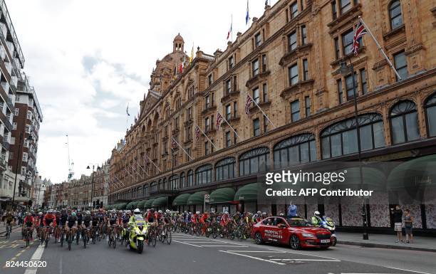 The peloton ride past Harrods department store on Brompton Road in west london at the start of the "Prudential RideLondon-Surrey Classic 2017", UCI...