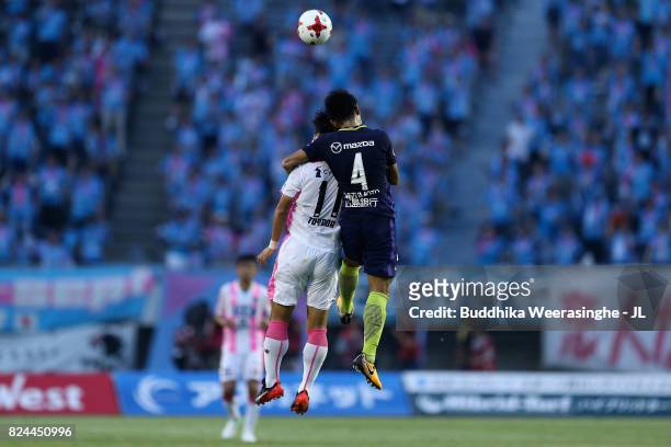 Hiroki Mizumoto of Sanfrecce Hiroshima and Yohei Toyoda of Sagan Tosu compete for the ball during the J.League J1 match between Sanfrecce Hiroshima...