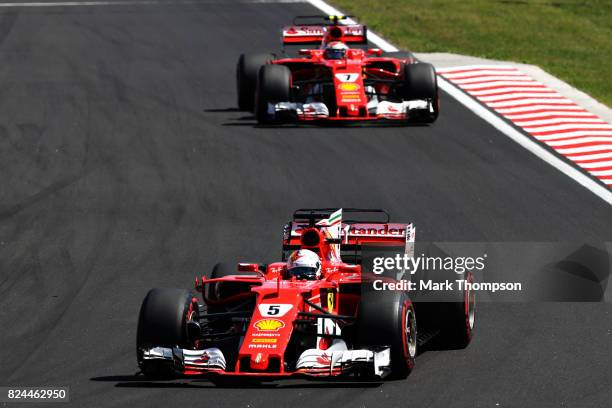Sebastian Vettel of Germany driving the Scuderia Ferrari SF70H leads Kimi Raikkonen of Finland driving the Scuderia Ferrari SF70H on track during the...