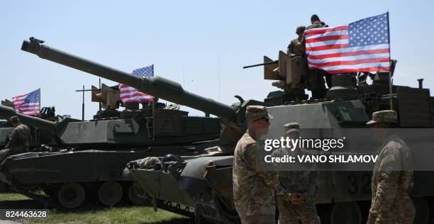 Soldiers stand by Abrams Battle Tanks bearing the US flag prior to the opening ceremony of the joint multinational military exercise 'Noble Partner...