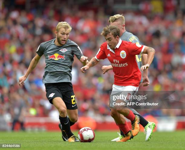 Benfica's Portuguese midfielder Andre Horta vies with Leipzig's Austrian midfielder Konrad Laimer during the pre-season friendly football match...