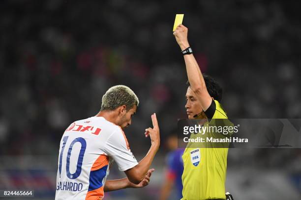 Thiago Galhardo do Nascimento Rocha of Albirex Niigata is shown a yellow card by referee Hiroyuki Kimura during the J.League J1 match between FC...