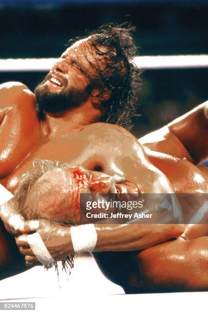 American wrestler Macho Man Randy Savage holds his opponent, fellow wrestler Hulk Hogan , in a headlock during an unspecified match, late 1980s.