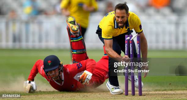 Bears bowler Grant Elliott narrowly misses running out Lancashire batsman Jos Buttler during the Natwest T20 Blast match between Birmingham Bears and...