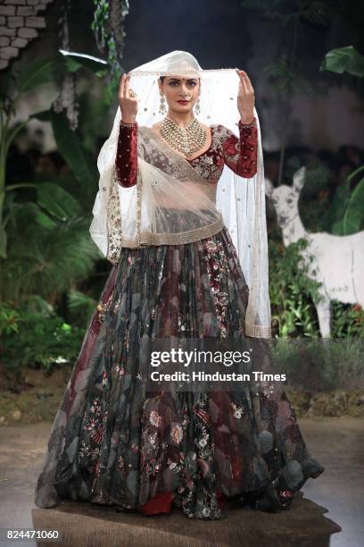 Bollywood actor Dia Mirza walks on the ramp showing creations made by designer Anju Modi during the day 4 of India Couture Week 2017, organised by...