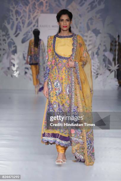 Model walks on the ramp showing creations made by designer Rahul Mishra during the day 4 of India Couture Week 2017, organised by Fashion Design...