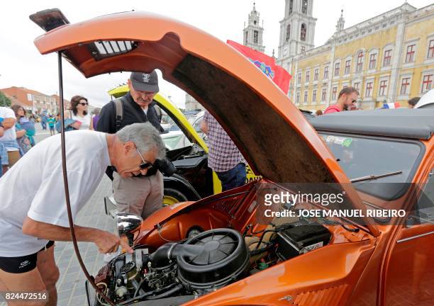 Visitor inspects the engine of a car parked in Mafra after the arrival of the parade of Citroen classic cars 2CV during the World 2017 2CV Meeting...
