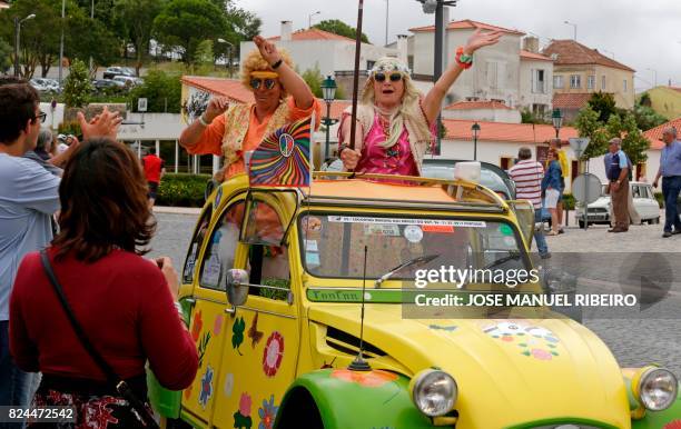 Participants and locals celebrate in Mafra the arrival of the the parade of Citroen classic cars 2CV during the World 2017 2CV Meeting July 30, 2017....