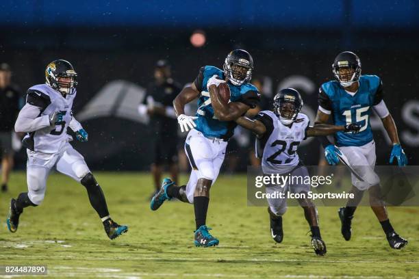 Jacksonville Jaguars running back Leonard Fournette runs past Jacksonville Jaguars cornerback Josh Johnson during the Jaguars training camp on July...