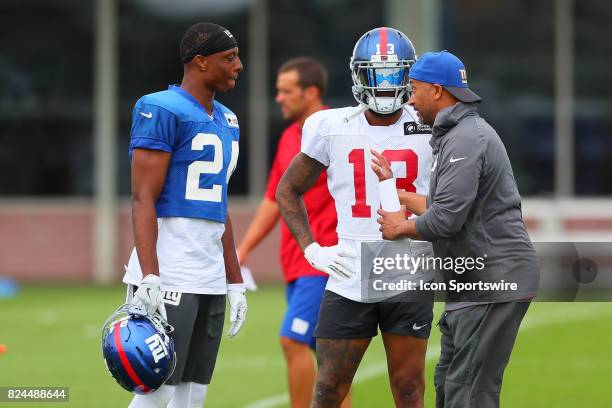 New York Giants wide receiver Odell Beckham talks with teammate New York Giants cornerback Eli Apple and a coach during 2017 New York Giants training...