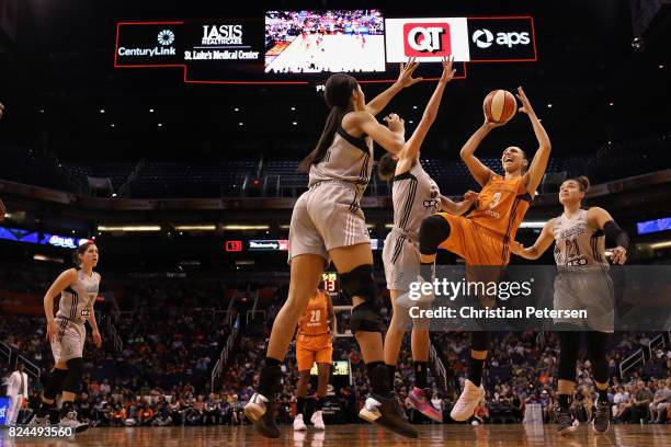 Diana Taurasi of the Phoenix Mercury attempts a shot over Isabelle Harrison of the San Antonio Stars during the first half of the WNBA game at...