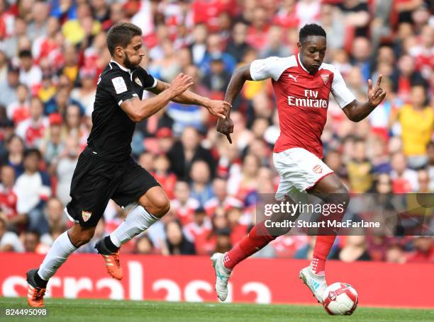 Danny Welbeck of Arsenal takes on Daniel Carrico of Seville during the Emirates Cup match between Arsenal and Seville at Emirates Stadium on July 30,...