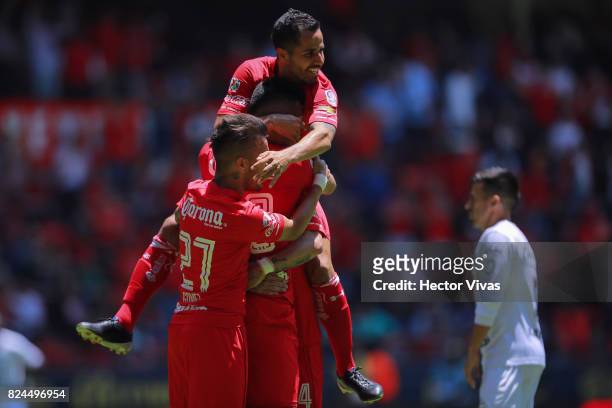 Fernando Uribe of Toluca celebrates with teammates after scoring the first goal of his team during the 2nd round match between Toluca and Leon as...