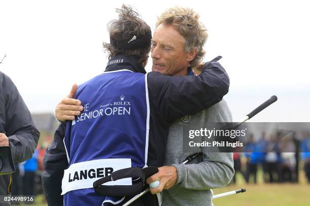 Bernhard Langer of Germany hugs his caddie Terry Holt during the final round of the Senior Open Championship at Royal Porthcawl Golf Club on July 30,...