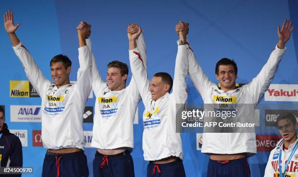 Matt Grevers, US Kevin Cordes, US Caeleb Remel Dressel and US Nathan Adrian celebrate on the podium after the final of the men's 4x100m medley relay...