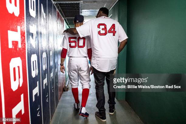 Former Boston Red Sox player David Ortiz walks through a hallway with Mookie Betts of the Boston Red Sox before a 2007 World Series Champion team...