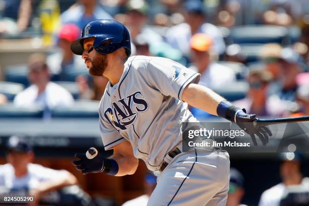 Trevor Plouffe of the Tampa Bay Rays follows through on a first inning RBI base hit against the New York Yankees at Yankee Stadium on July 30, 2017...