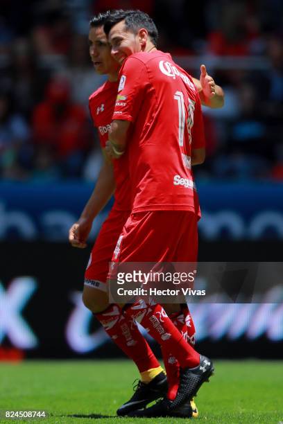 Rubens Sambueza of Toluca celebrates with teammate after scoring the third goal of his team during the 2nd round match between Toluca and Leon as...