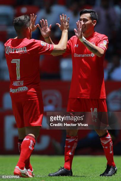 Rubens Sambueza of Toluca celebrates with teammate Gabriel Hauche after scoring the third goal of his team during the 2nd round match between Toluca...