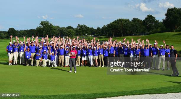 Jordan Smith of England poses with the trophy and the volunteers after winning the Porsche European Open during the Porsche European Open - Day Four...