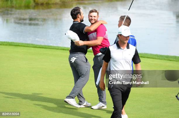 Jordan Smith of England hugs with Alexander Levy of France forcing a play off during the Porsche European Open - Day Four at Green Eagle Golf Course...