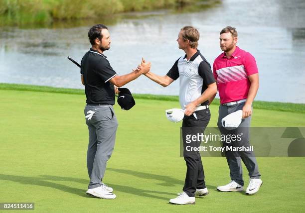 Alexander Levy of France shakes hands with Jens Fahrbring of Sweden at the end of their round during the Porsche European Open - Day Four at Green...