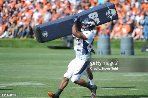 Denver Broncos linebacker Corey Nelson hits a tackling dummy during training camp Sunday, July 30, 2017.