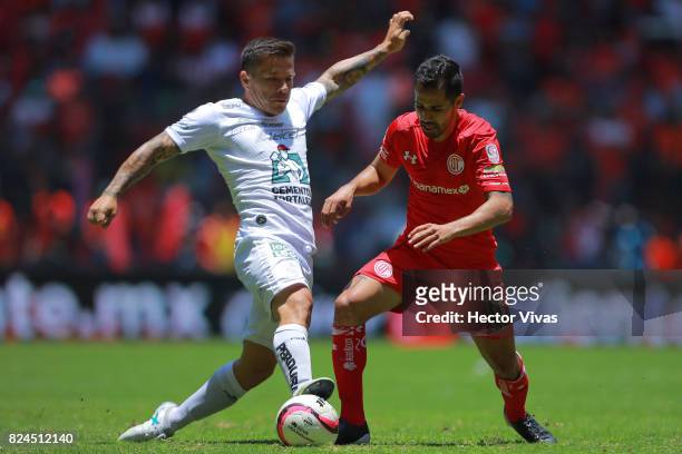 Alvaro Ramos of Leon struggles for the ball with Rodrigo Lopez of Toluca during the 2nd round match between Toluca and Leon as part of the Torneo...