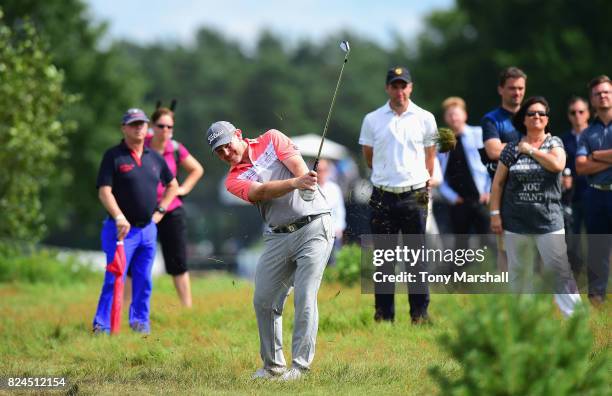 Stephen Gallacher of Scotland plays his second shot on the 18th fairway during the Porsche European Open - Day Four at Green Eagle Golf Course on...