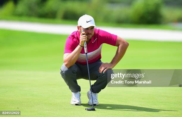 Jordan Smith of England lines up his putt on the 11th green during the Porsche European Open - Day Four at Green Eagle Golf Course on July 30, 2017...