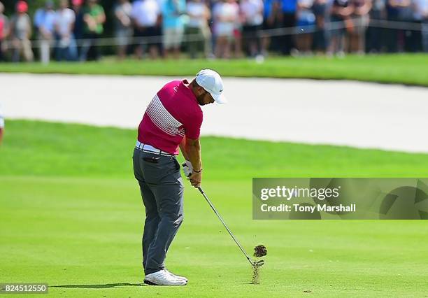 Jordan Smith of England plays his approach shot on the 12th green during the Porsche European Open - Day Four at Green Eagle Golf Course on July 30,...