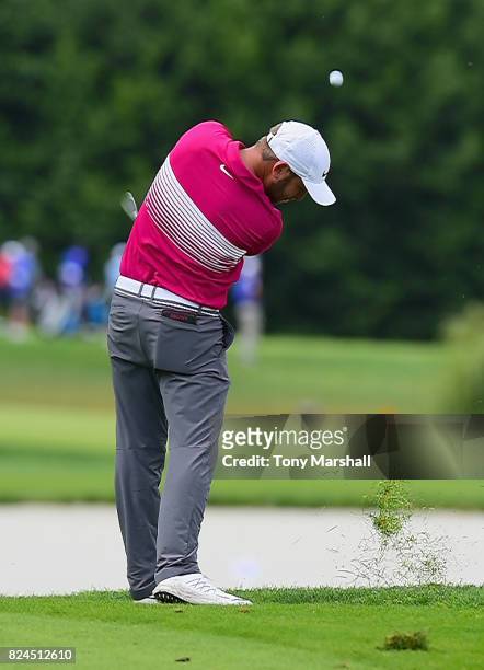 Jordan Smith of England plays his approach shot on the 6th green during the Porsche European Open - Day Four at Green Eagle Golf Course on July 30,...