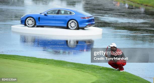 Siddikur Rahman of Bangladesh lines up his putt on the 18th green during the Porsche European Open - Day Four at Green Eagle Golf Course on July 30,...