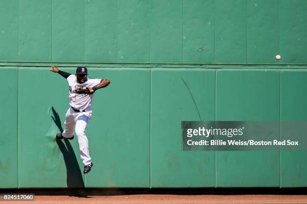 Jackie Bradley Jr. #19 of the Boston Red Sox attempts to catch a line drive off of the wall during the sixth inning of a game against the Kansas City...