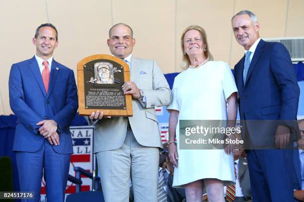 Ivan Rodriguez poses for a photograph as he is presented his plaque with Hall of Fame President Jeff Idelson, Hall of Fame chairman of the board Jane...