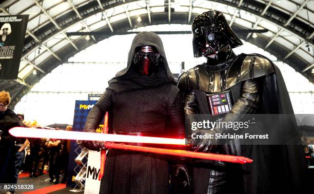 Cosplayers dressed as Kylo Ren and Darth Vader of Star Wars attend MCM Comic Con at Manchester Central on July 30, 2017 in Manchester, England.