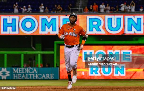 Marcell Ozuna of the Miami Marlins hits a three run home run in the ninth inning during the game between the Miami Marlins and the Cincinnati Reds at...