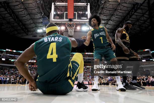 Josh Childress of the Ball Hogs helps Derrick Byars off the floor during the game against the Killer 3s during week six of the BIG3 three on three...