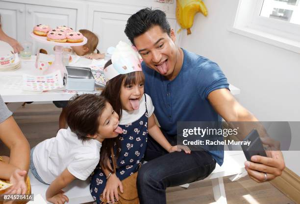 Mario Lopez, daughter Gia Francesca Lopez, and son Dominic Lopez attend the Num Noms event hosted by Tiffani Thiessen at Au Fudge Los Angeles on July...