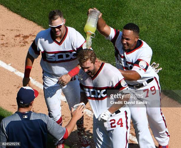 Matt Davidson of the Chicago White Sox is greeted by Jose Abreu of the after hitting a game winning two-run homer against the Cleveland Indians on...